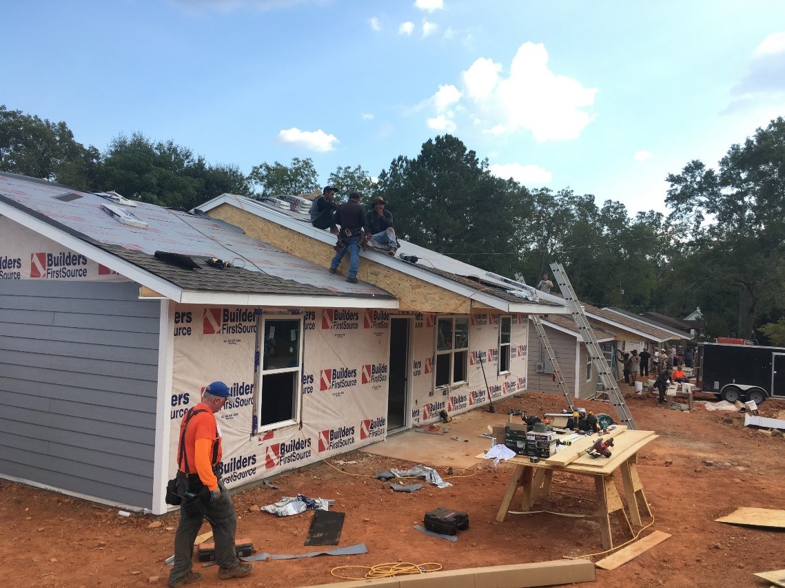 GAF volunteers help rebuild a house destroyed by a natural disaster.